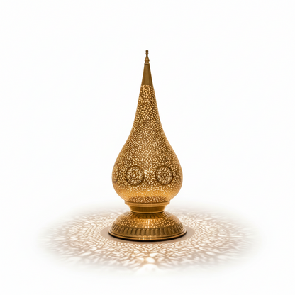 Decorative gold lamp casting a pattern on a white background
