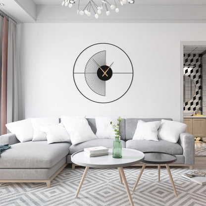 Modern living room with a gray sectional sofa, round coffee table, and decorative wall clock.