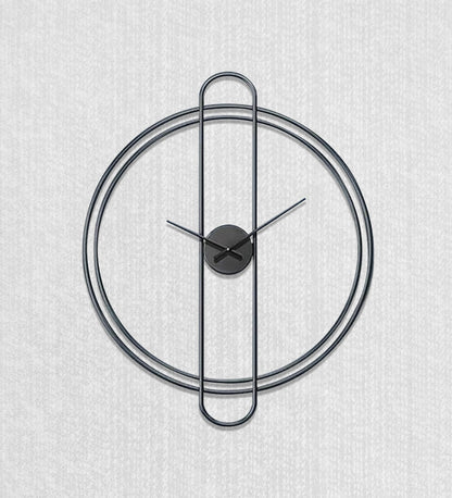 Modern wall clock with black metal design on a light gray background