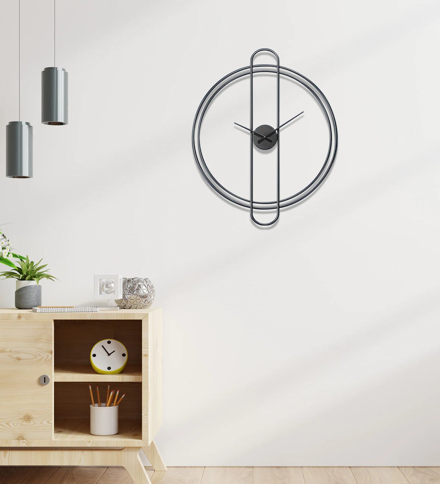 Modern wall clock on a white wall with a wooden cabinet and decorative items.