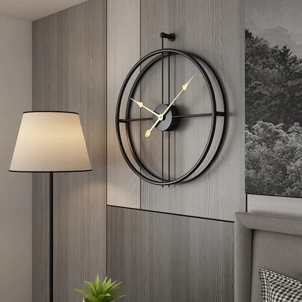 Decorative wall clock on a wooden wall with a lamp and plant in the background