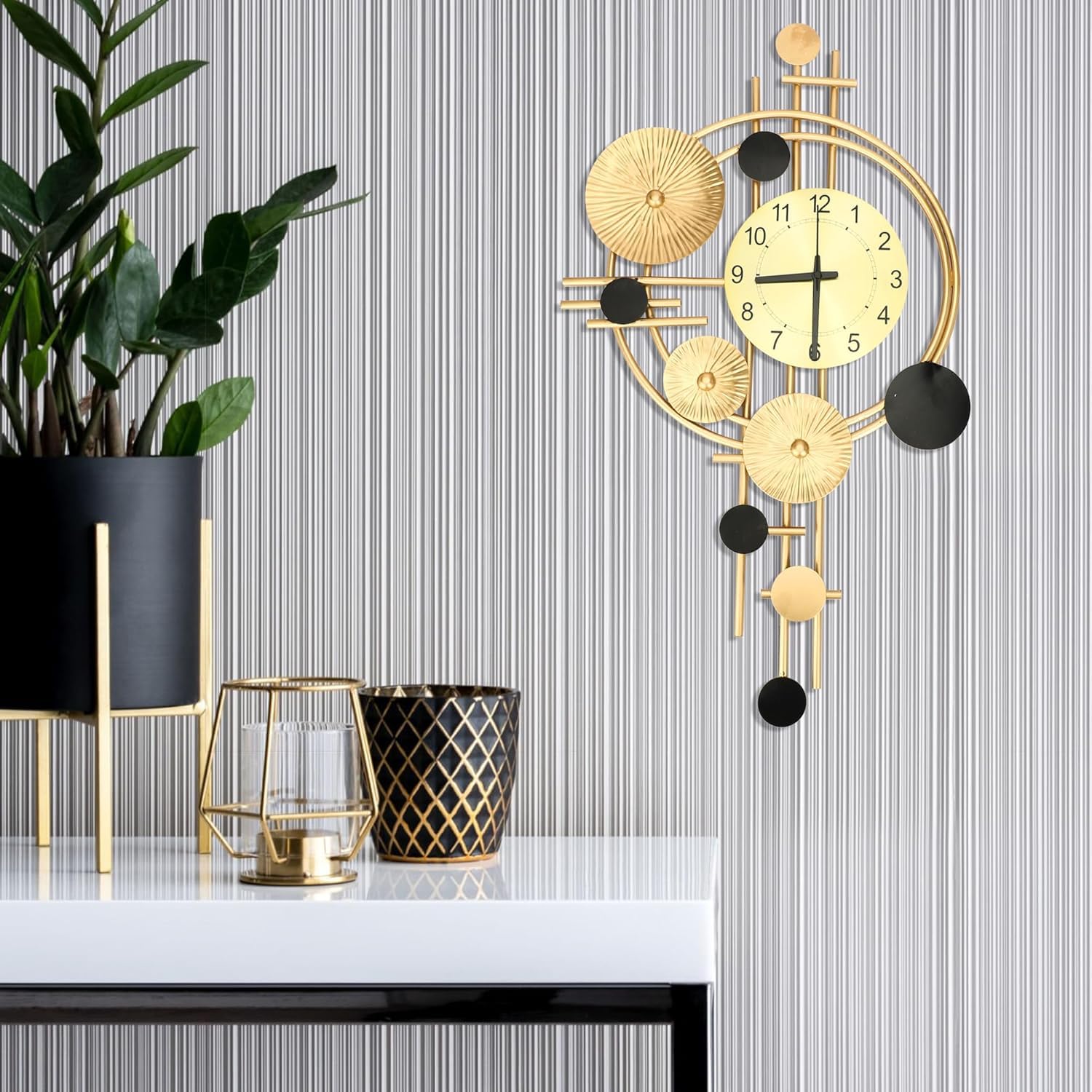 Decorative wall clock with gold and black design on a striped wall.
