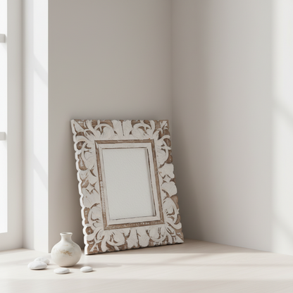 Decorative photo frame with intricate patterns on a light surface near a window.
